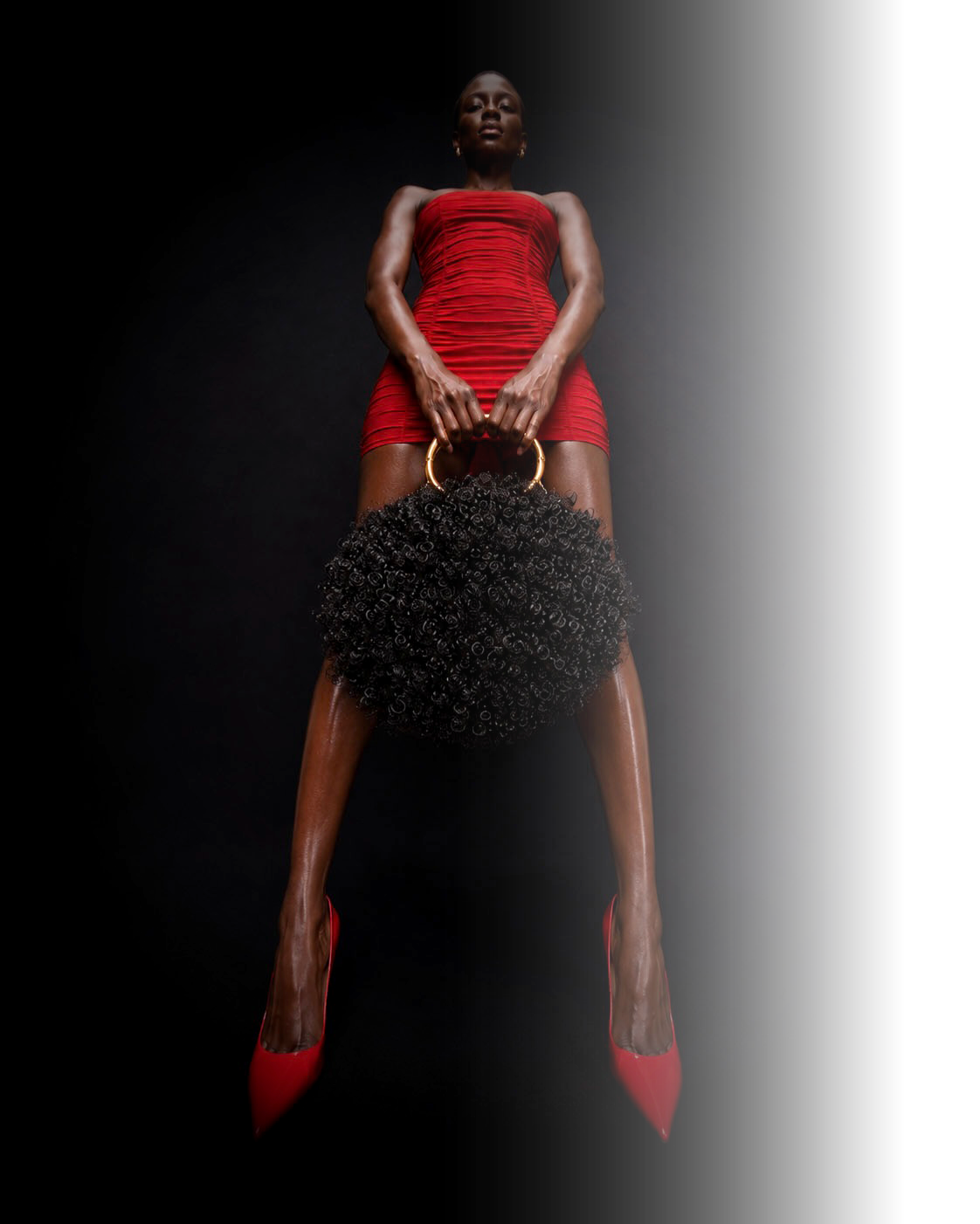 Model holding an Afro Purse